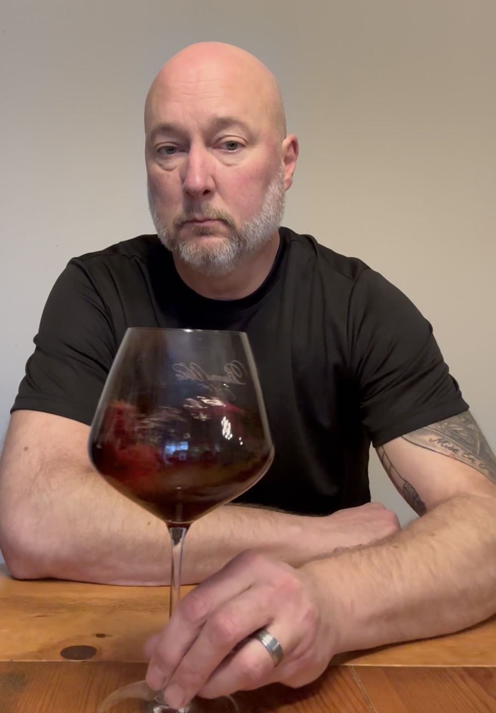 Dale Benson holding a glass of wine