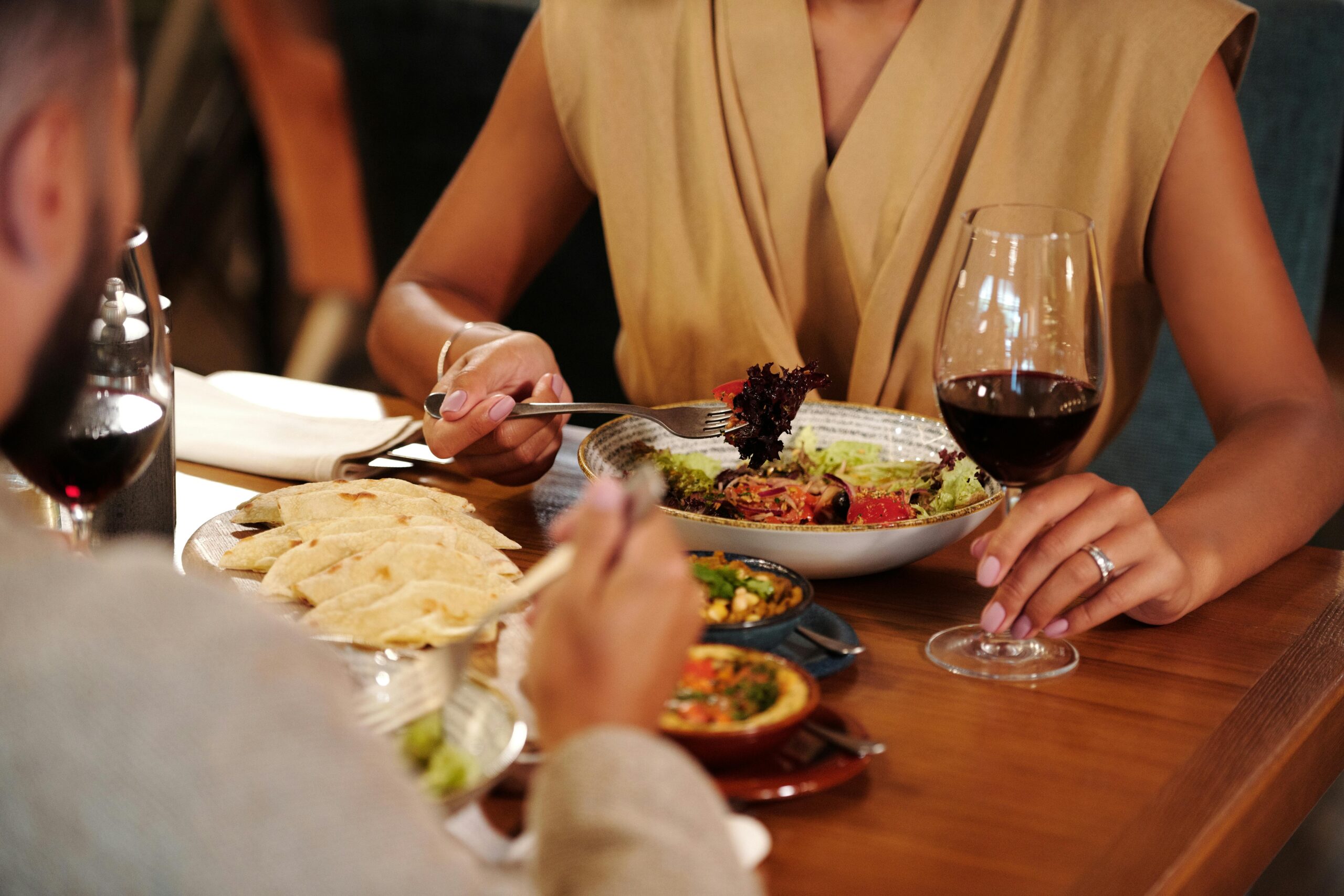 A classic wine bottle and glass on a simple table setting