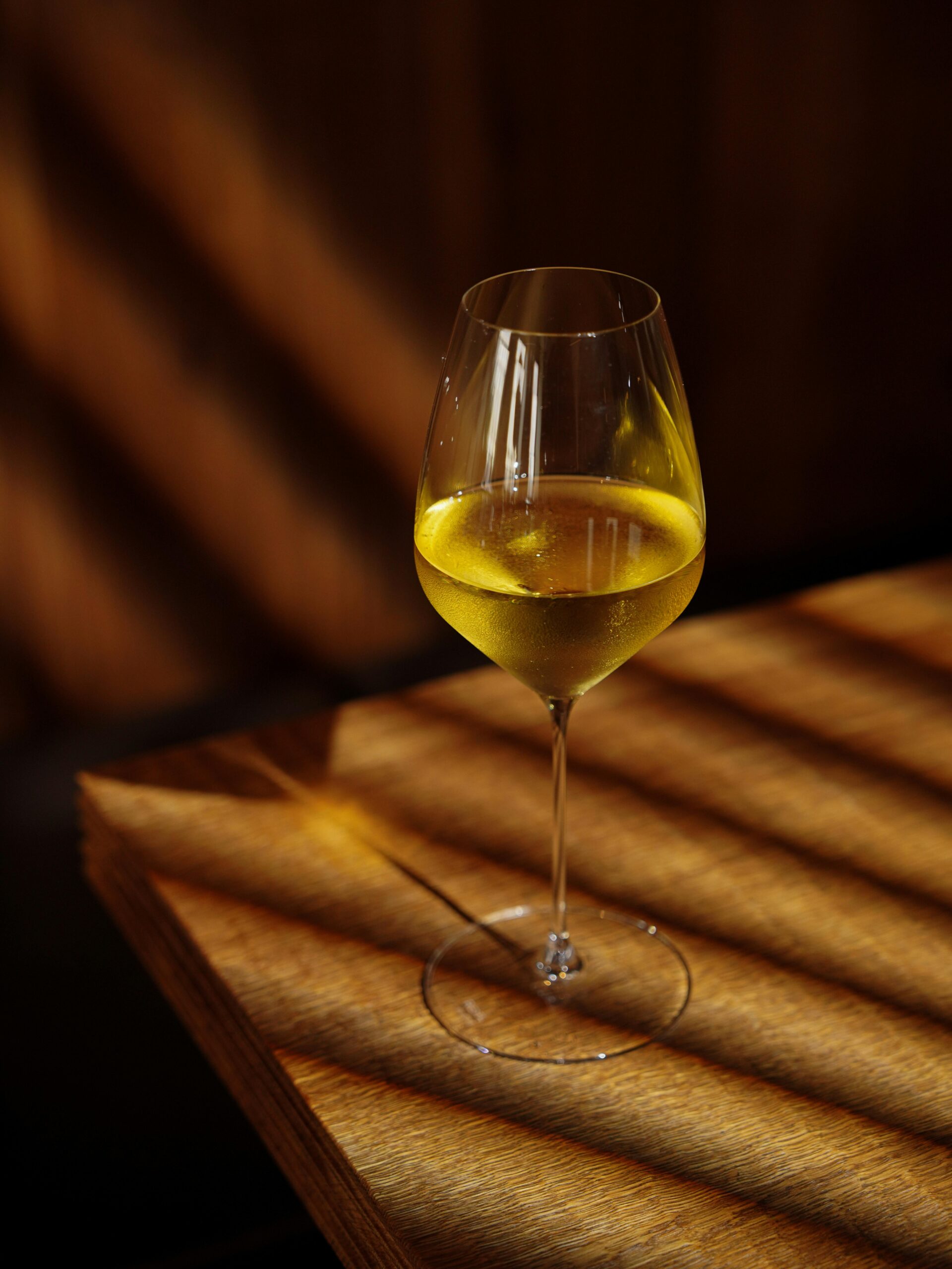 A small wine rack and bottles in a normal home setting with warm light